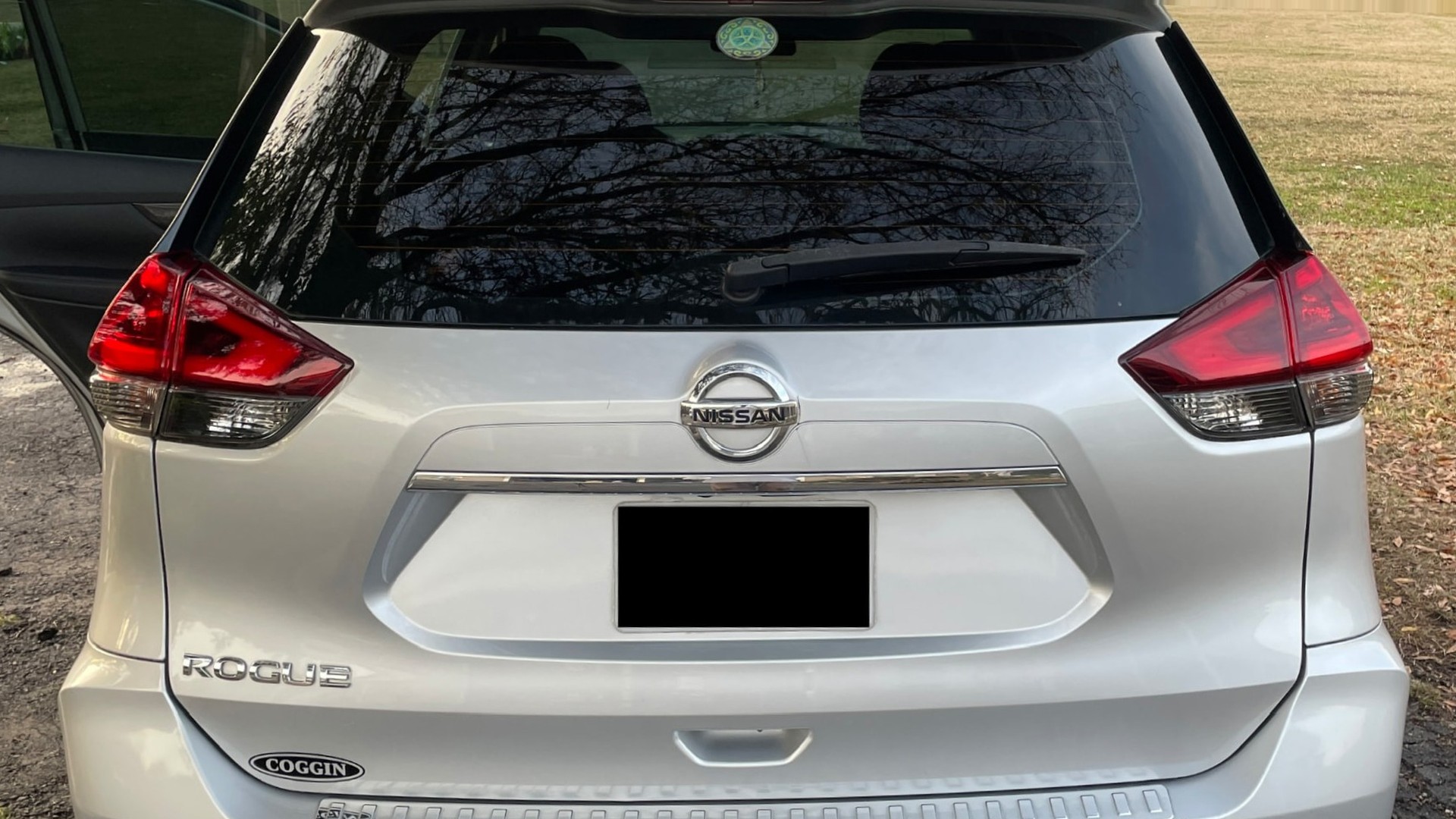 Clean silver Nissan Rogue rear exterior after detailing